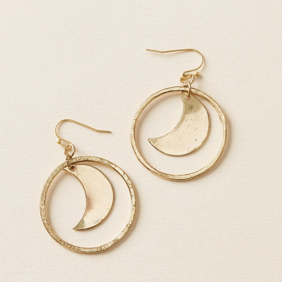 Crescent Moon Gold Hoop Dangle Earrings: handcrafted drop earrings feature a smooth, crescent moon charm encircled by a hand hammered loop charm and ball-tipped fish hooks in gold finish