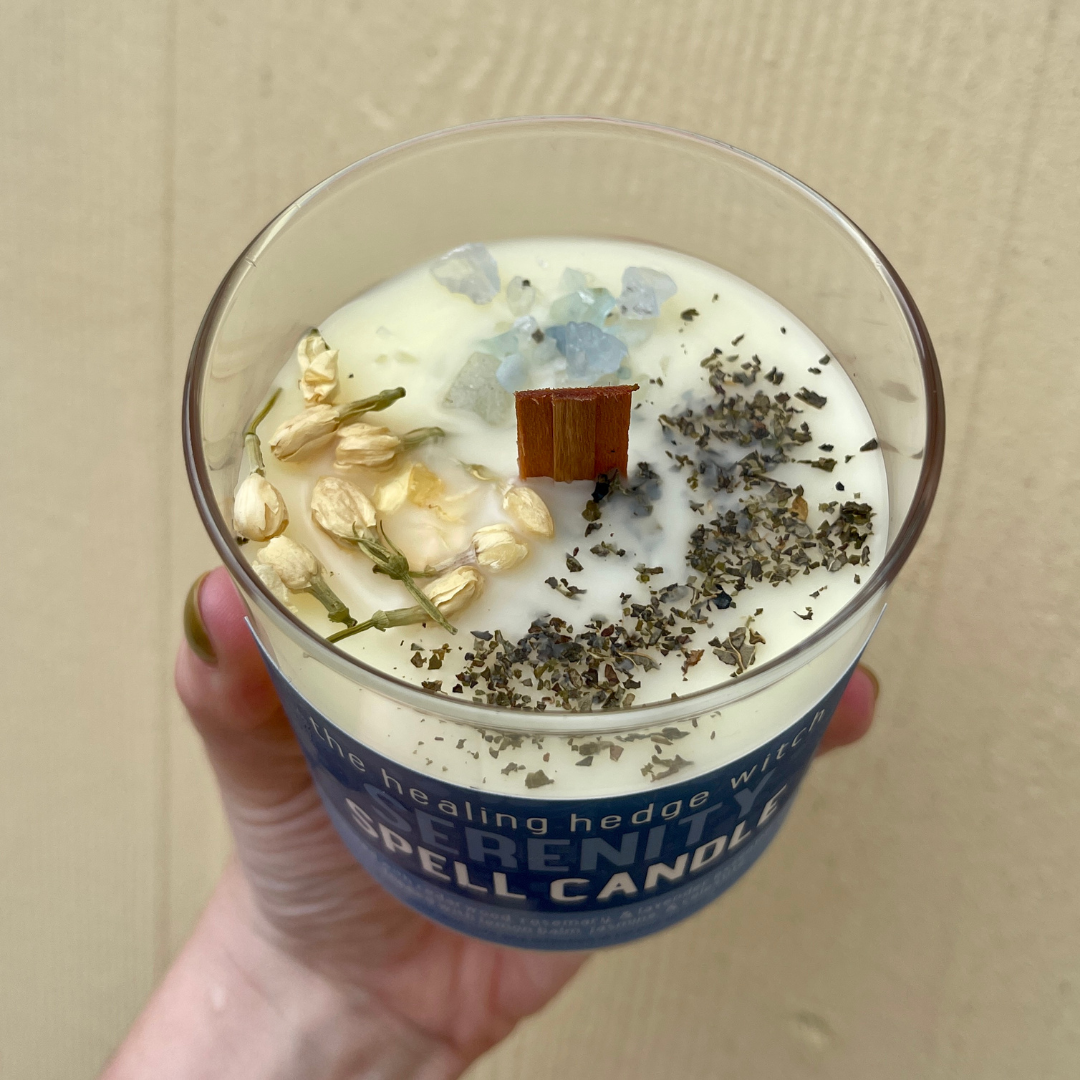 8 ounce serenity spell candle scented with cedarwood, rosemary, &amp; lavender essential oil; topped with lemon balm, jasmine, &amp; celestite