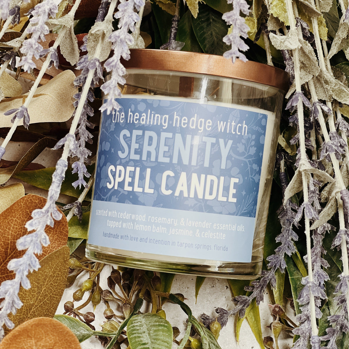 8 ounce serenity spell candle scented with cedarwood, rosemary, &amp; lavender essential oil; topped with lemon balm, jasmine, &amp; celestite