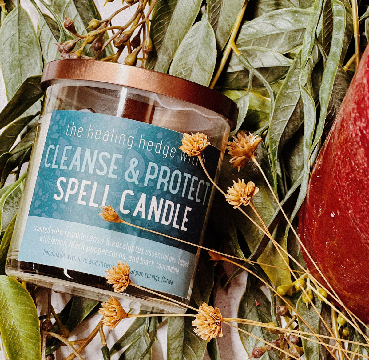 Cleanse &amp; Protect Spell Candle Cleanse and protect your space and energy with this hand-poured, small-batch, 8-ounce spell candle. Scented with frankincense and eucalyptus essential oils &amp; topped with black peppercorns, lemon, and black tourmaline.