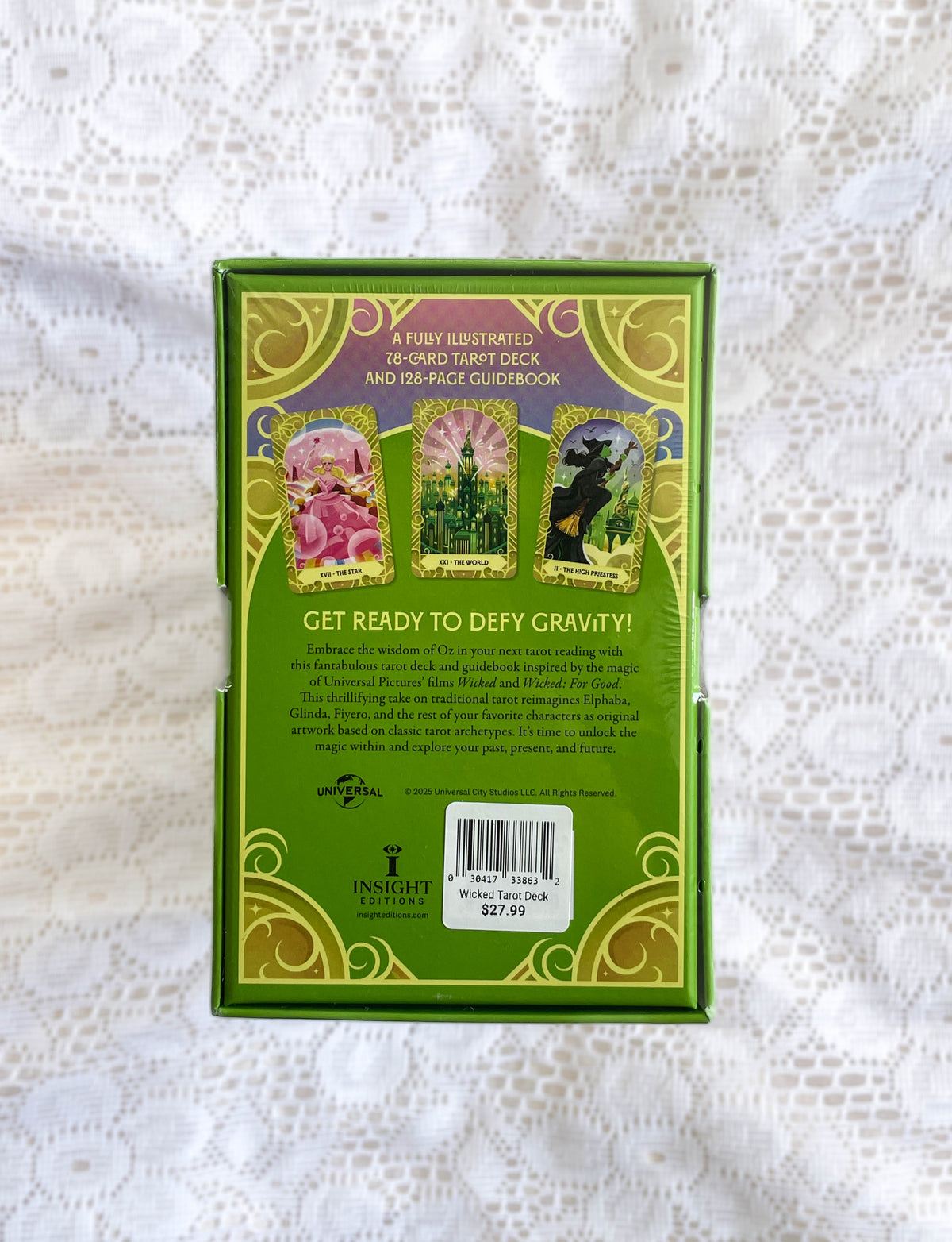 The back of The Healing Hedge Witch's Wicked Tarot Deck box shows three illustrated cards, a deck and guidebook description, Oz-inspired green and gold designs, a barcode, price tag, and the Insight Editions logo.
