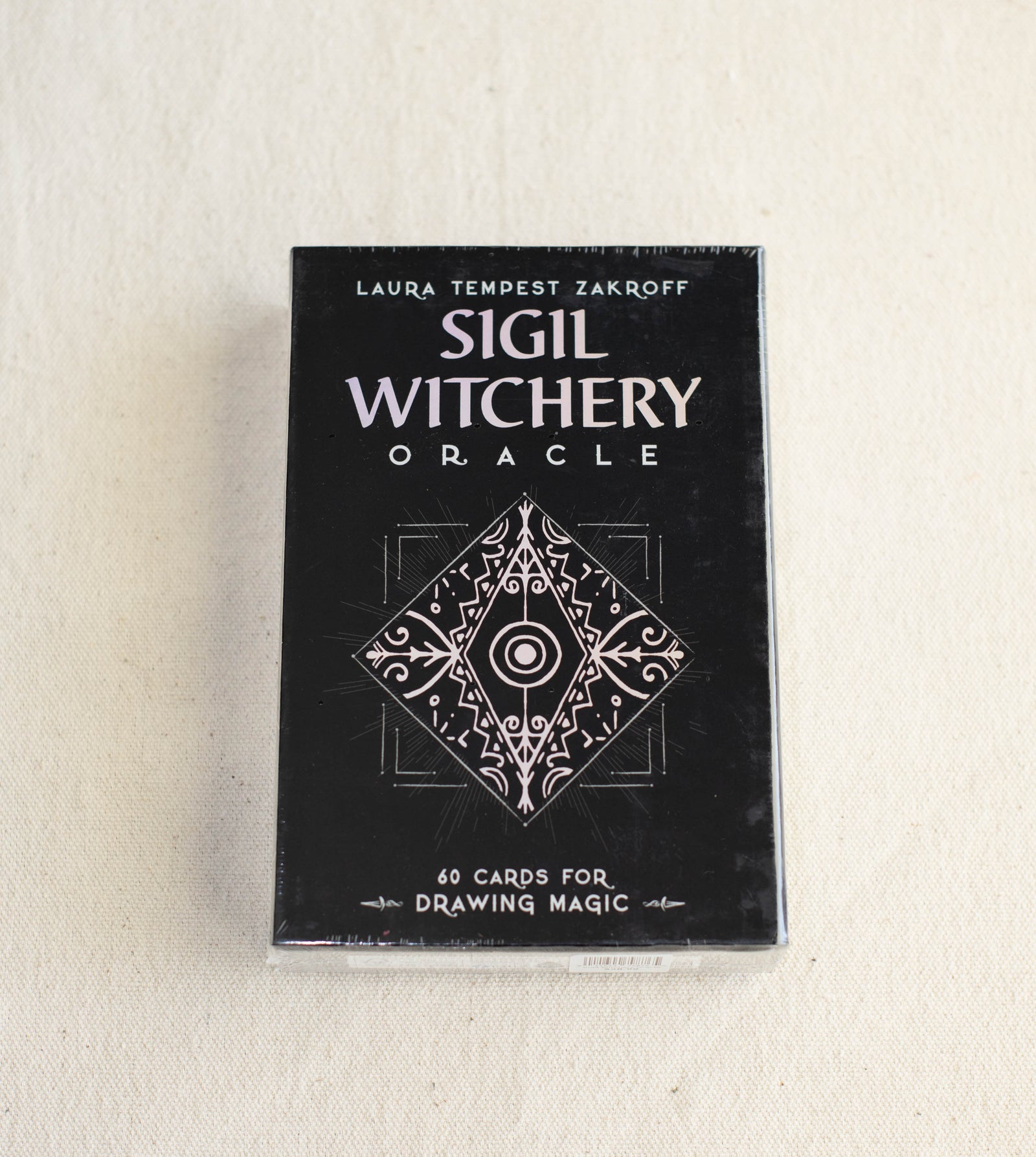 The Healing Hedge Witch’s Sigil Witchery Oracle is a boxed set featuring 60 cards for drawing magic, designed by Laura Tempest Zakroff with a mystical geometric cover.