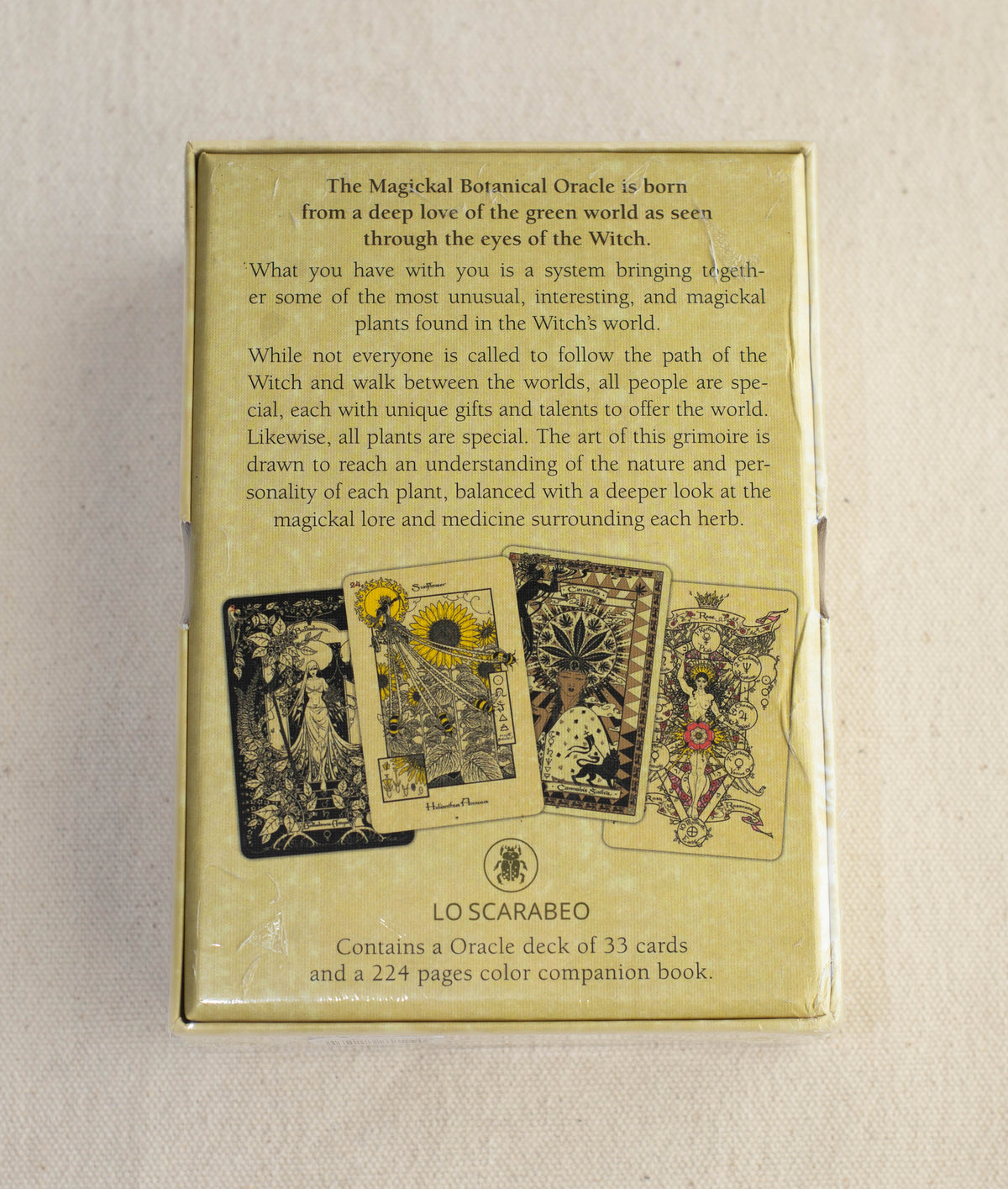 The back of The Magickal Botanical Oracle by The Healing Hedge Witch displays deck info and three detailed botanical-themed oracle cards. The box includes 33 oracle cards and a color companion book.