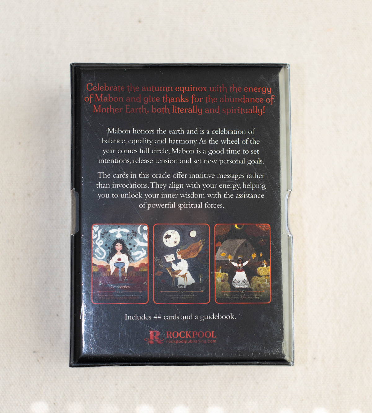 Back of the Seasons of the Witch Mabon Oracle by The Healing Hedge Witch, with autumn-themed Mabon text, 3 sample card illustrations, info on 44 cards and a guidebook included, plus The Healing Hedge Witch logo at the bottom.