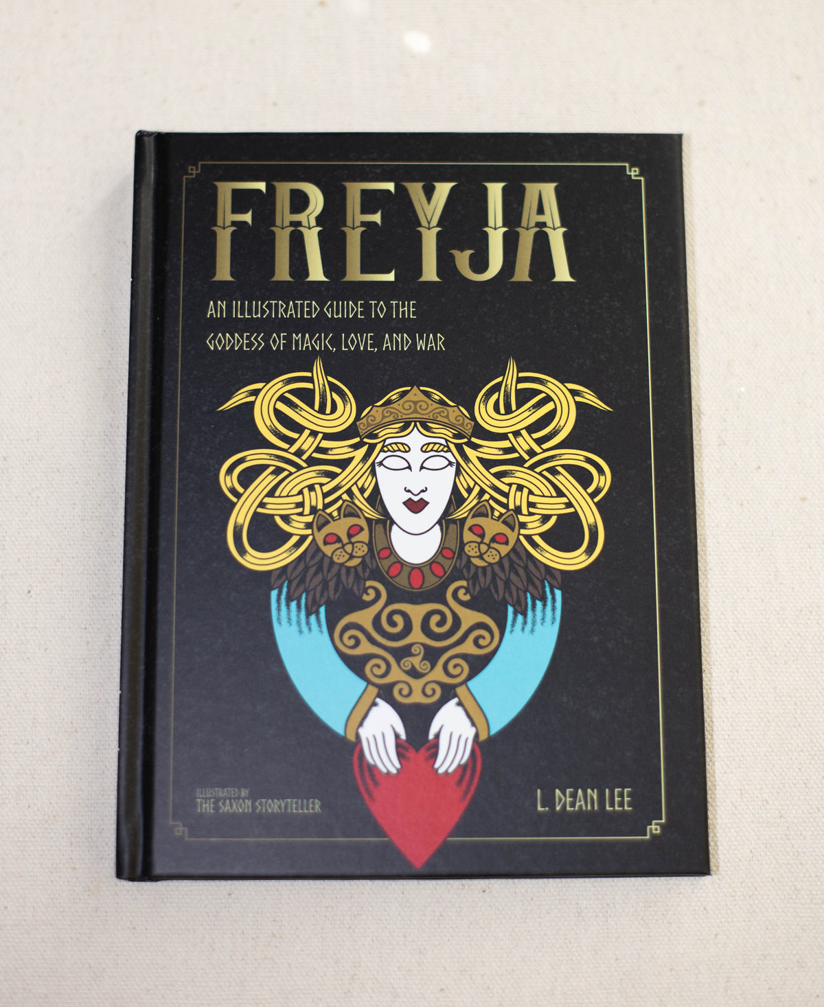Freyja by The Healing Hedge Witch features a stylized illustration of the goddess with intricate golden hair, holding a red heart.