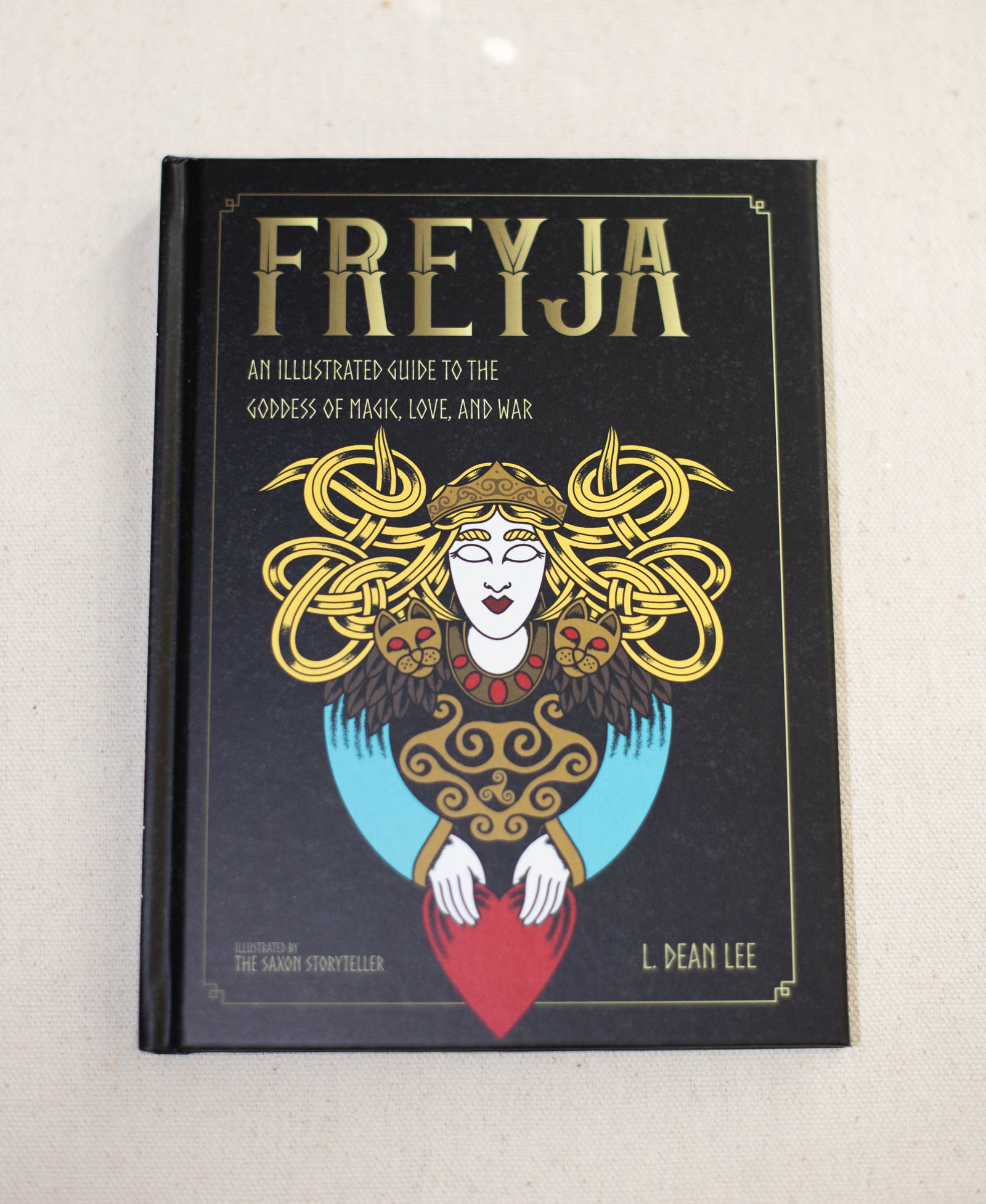 Freyja by The Healing Hedge Witch features a stylized illustration of the goddess with intricate golden hair, holding a red heart.