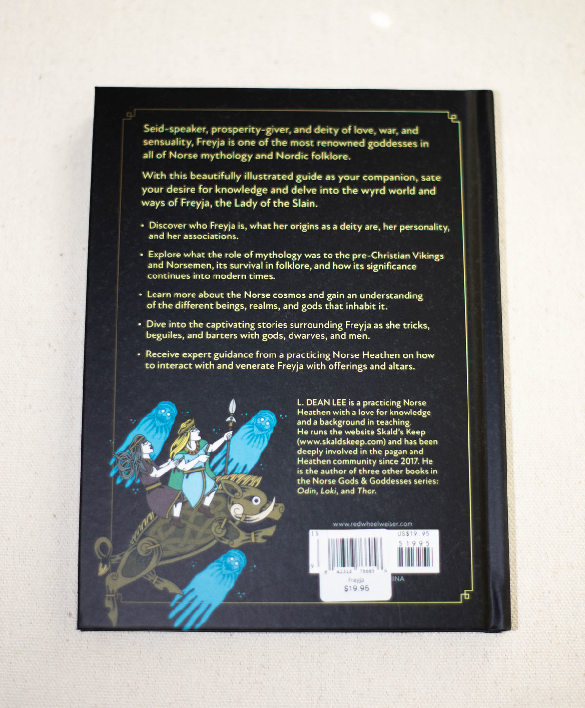 The back cover of "Freyja" by The Healing Hedge Witch features illustrated Norse figures in a cat-drawn chariot, with book and author details, plus a barcode and $19.95 price tag at the bottom.