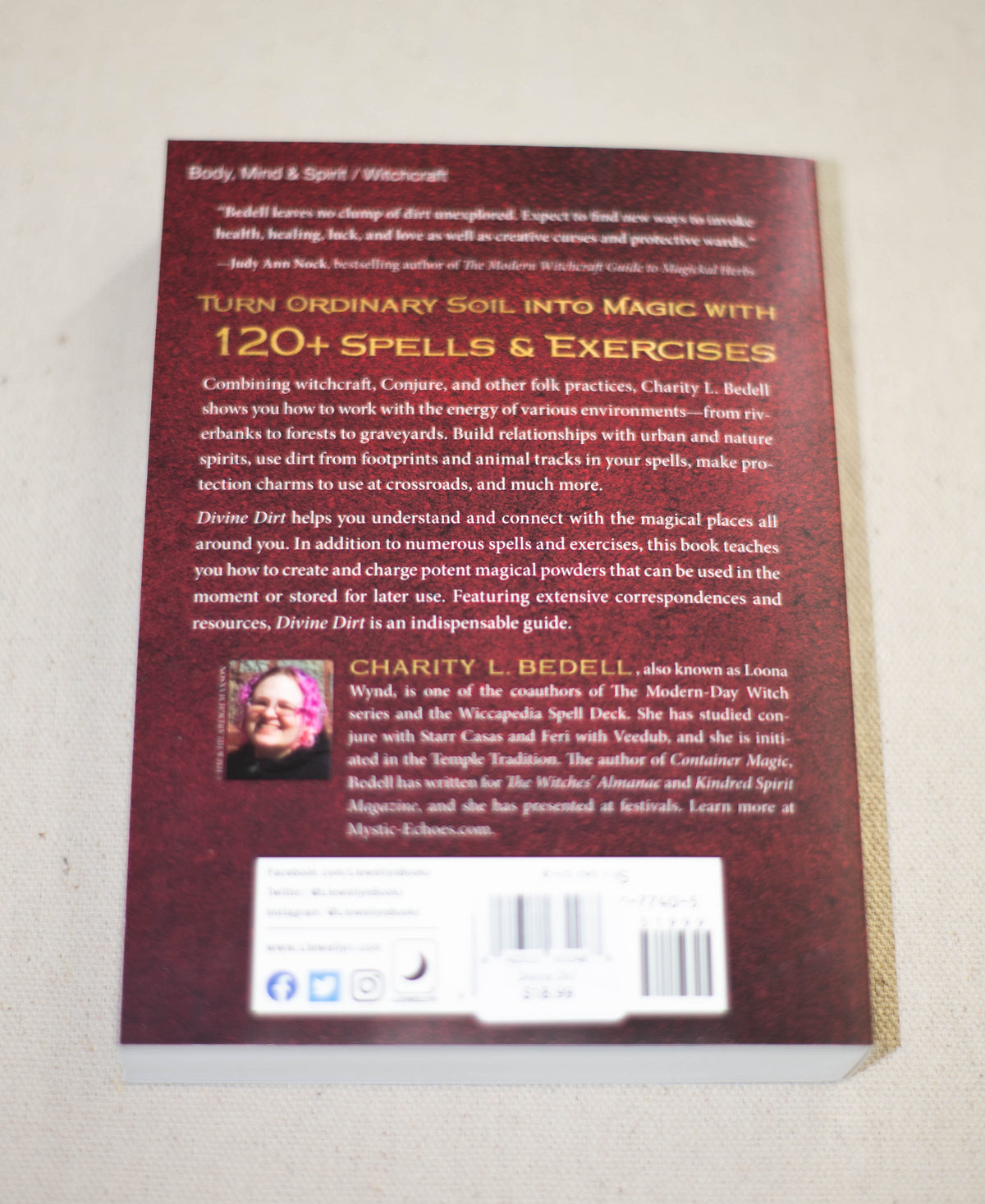 The back cover of Divine Dirt by The Healing Hedge Witch highlights 120+ spells and exercises for everyday magic. Written by Charity Bedell, it features a barcode and publisher info at the bottom.