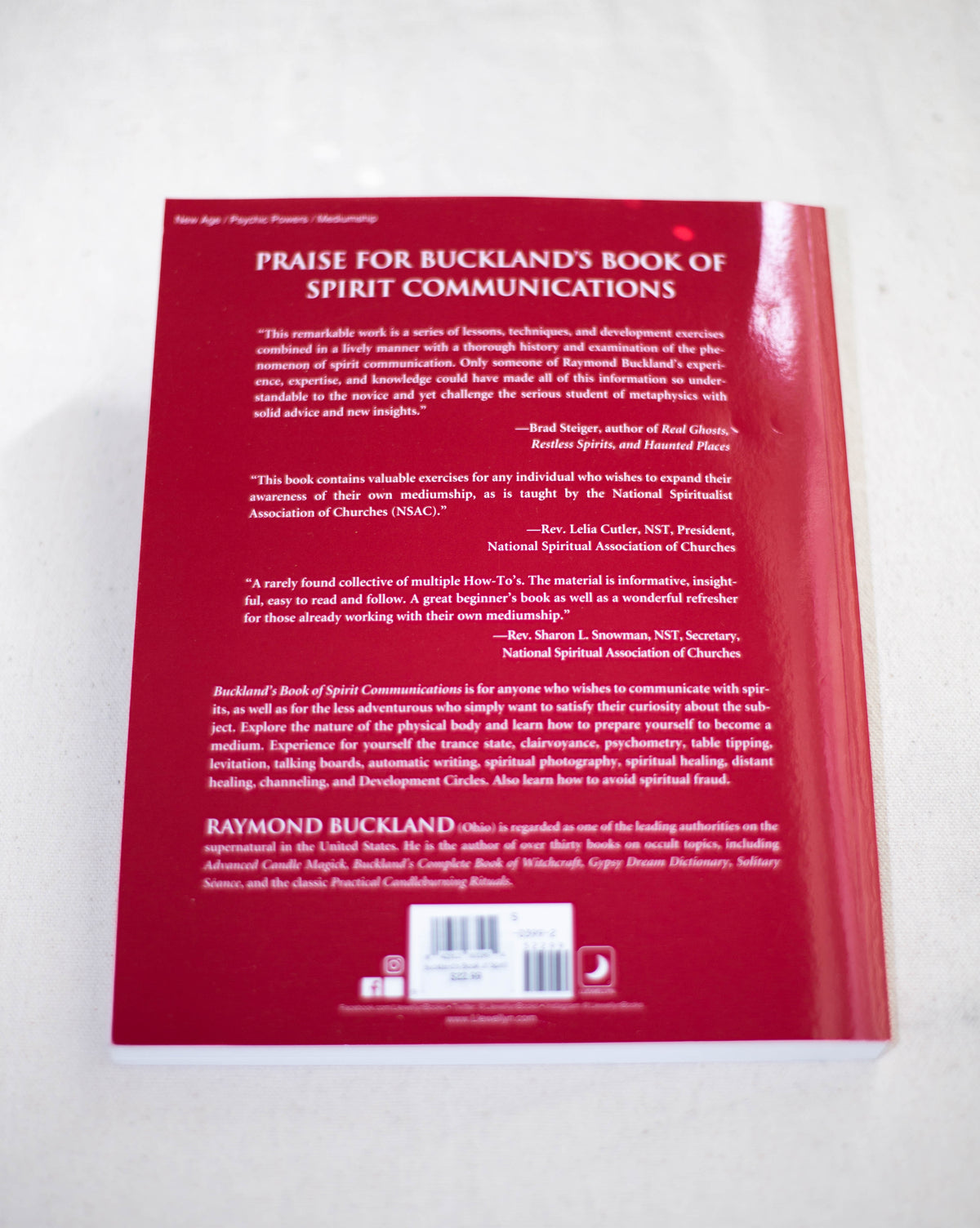 The back cover of Buckland's Book of Spirit Communications by The Healing Hedge Witch displays white praise and endorsements on red, plus a barcode and a brief author bio at the bottom.