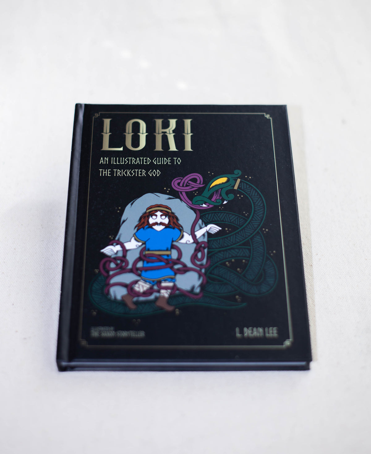 Loki by The Healing Hedge Witch features a cartoon illustration of Loki entangled in serpents on a black cover with gold decorative elements.