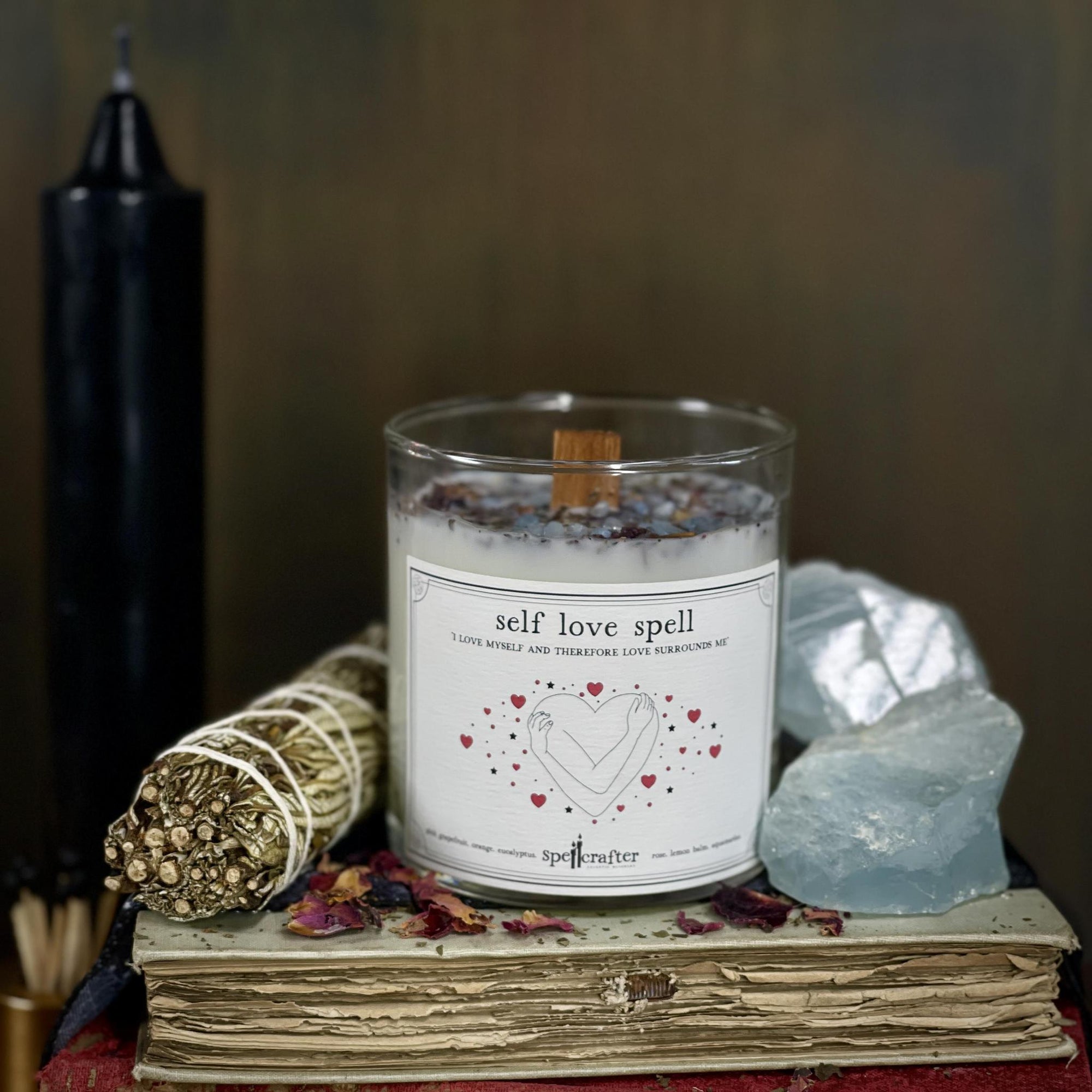Self Love Spell Candle hand poured, small-batch 8-ounce spell candle. Scented with pink grapefruit, orange, and eucalyptus essential oils &amp; topped with rose, lemon balm, and aquamarine.