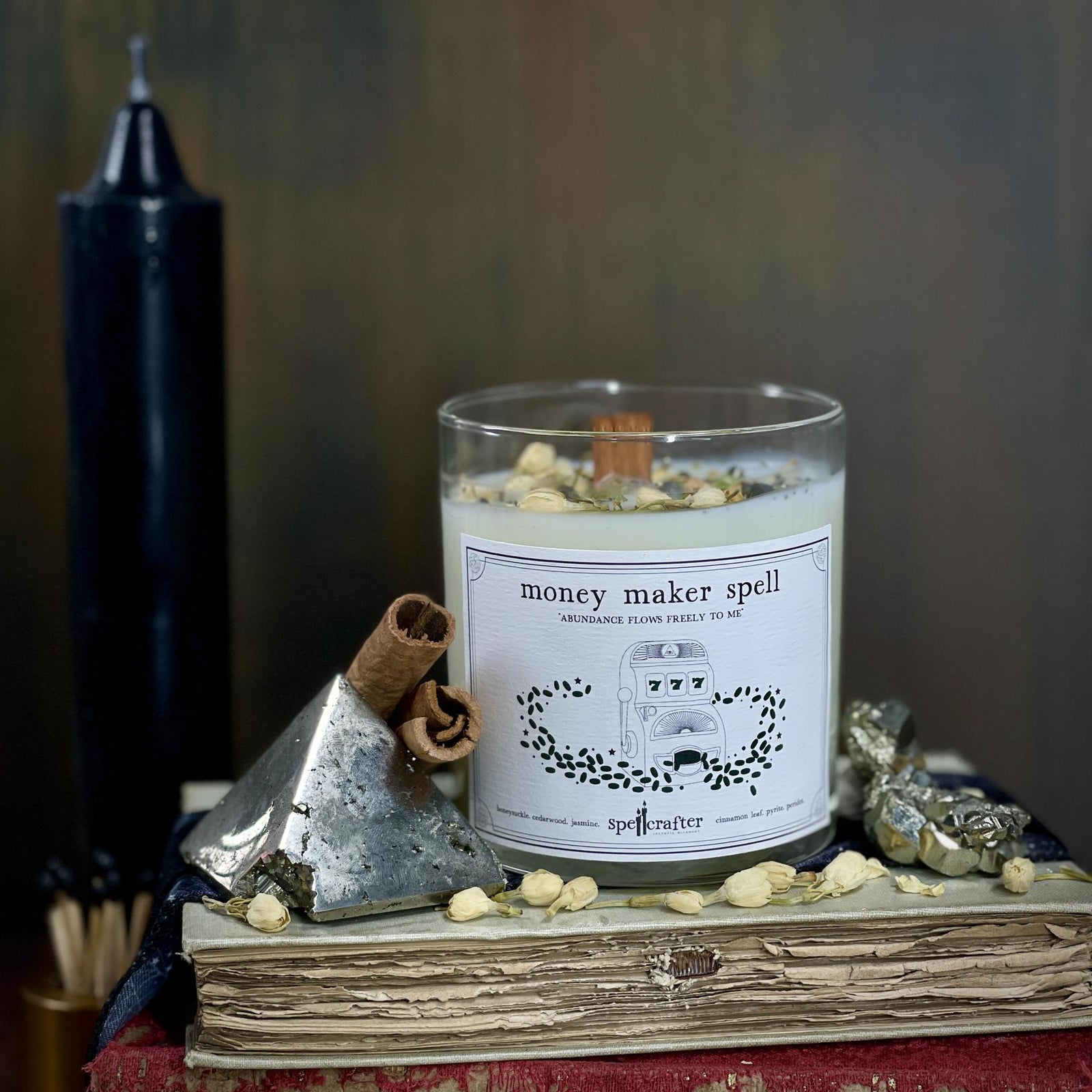 money maker spell candle Invite prosperity in with this hand poured, small-batch 8-ounce spell candle. Scented with honeysuckle, cedarwood, and cinnamon leaf essential oils & topped with jasmine, pyrite, and peridot