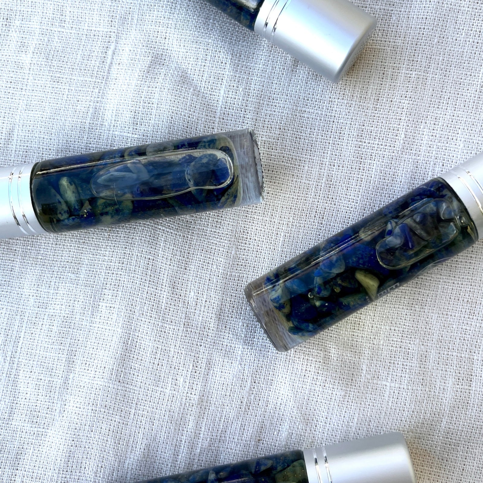 Meditation Crystal Charged Essential Oil Roller A blend of frankincense, lavender, and sweet orange essential oils with lapis lazuli chips