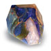 The T. S. Pink Corp SoapRocklet is a multicolored, faceted soap featuring blue, orange, green, and pink hues, shown against a white background.