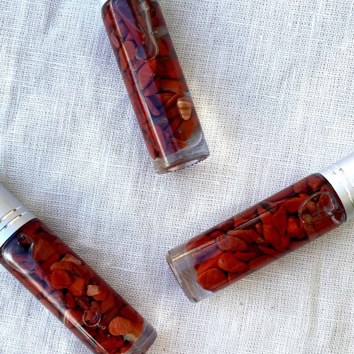 Passion Crystal Charged Essential Oil Roller A blend of cedarwood, patchouli, and rose essential oils with red jasper chips