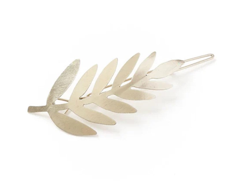 The Matr Boomie Silver Finish Fern Barrette features smooth, flat, overlapping fern leaf segments in a metallic design, shown against a plain white background.