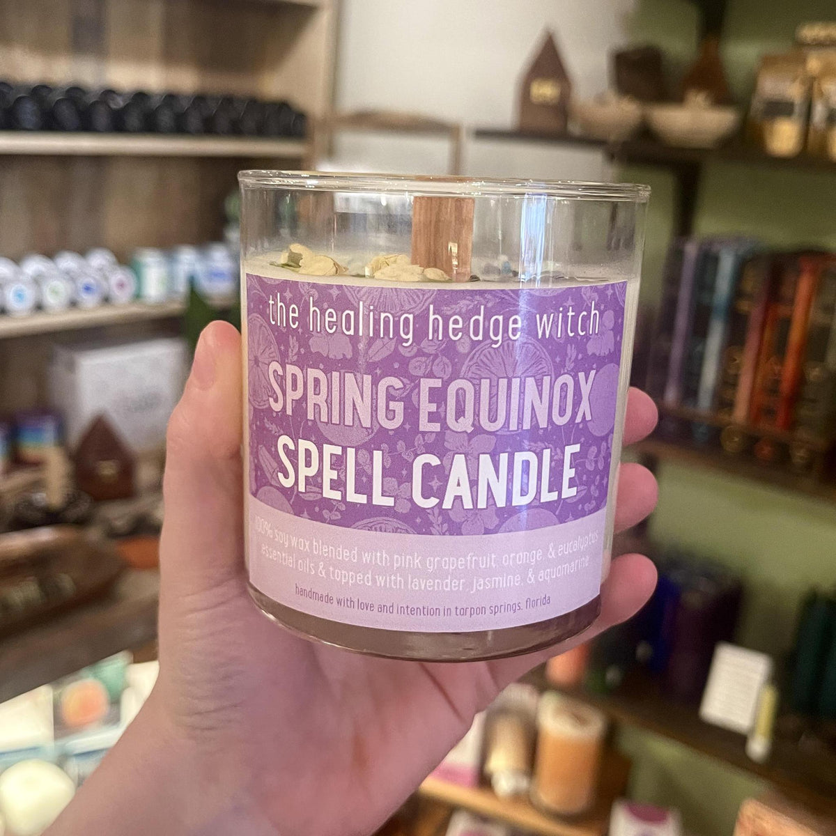 Spring Equinox Spell Candle hand-poured, small-batch spell candle! Scented with pink grapefruit, orange, and eucalyptus essential oils and topped with lavender, jasmine, and aquamarine.