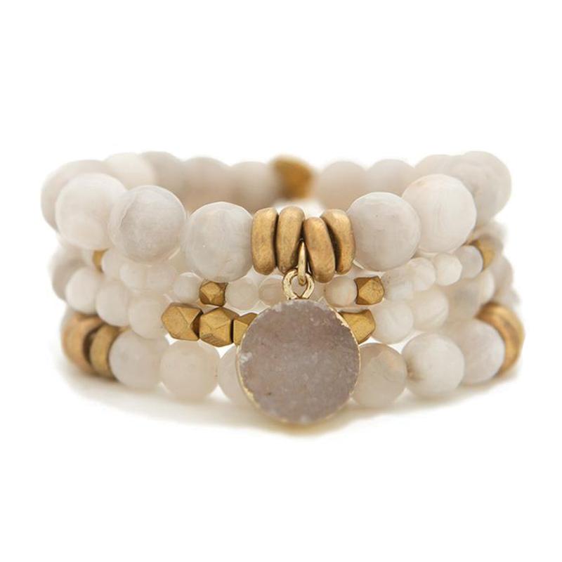 The Gray Agate Gemstone Bracelet is gift-ready, featuring multiple strands of round white and gold beads, a large circular gray agate stone charm, and several gold accent beads.